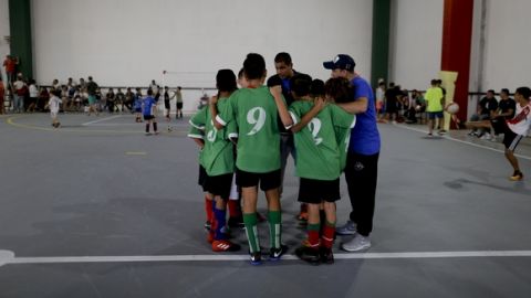 In this March 18, 2017 photo, Club Social Parque players huddle with their coach before a match at the youth soccer academy Club Social Parque in a working class neighborhood of Buenos Aires, Argentina. The humble youth academy has perhaps produced more world-class players than any other. (AP Photo/Natacha Pisarenko)