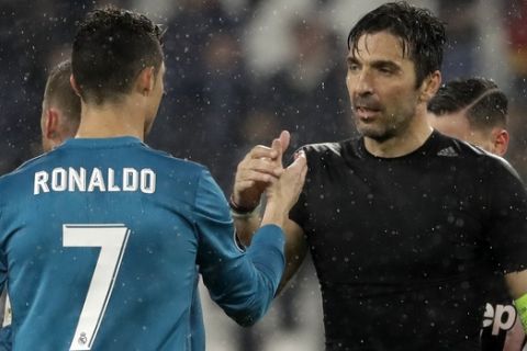 Juventus goalkeeper Gianluigi Buffon, right, shakes hands with Real Madrid's Cristiano Ronaldo after the Champions League, round of 8, first-leg soccer match between Juventus and Real Madrid at the Allianz stadium in Turin, Italy, Tuesday, April 3, 2018. Real won 3-0. (AP Photo/Luca Bruno)