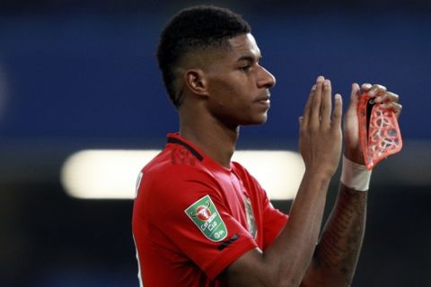 Manchester United's Marcus Rashford applauds at the end of the English League Cup soccer match between Chelsea and Manchester United at Stamford Bridge in London, Wednesday, Oct. 30, 2019. Rashford scored twice in Manchester United's 2-1 win. (AP Photo/Ian Walton)