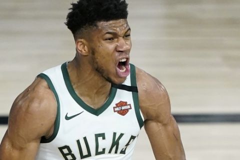 Milwaukee Bucks forward Giannis Antetokounmpo (34) reacts after he scored against the Orlando Magic during the second half of an NBA basketball first round playoff game, Thursday, Aug. 20, 2020, in Lake Buena Vista, Fla. (AP Photo/Ashley Landis, Pool)