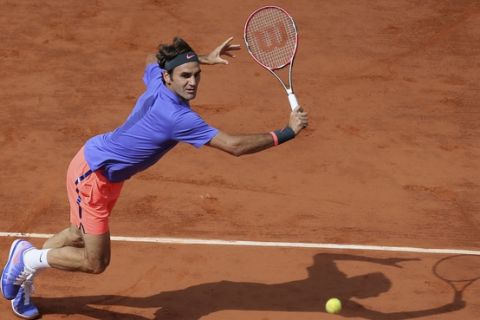 FILE - In this June 2, 2016, file photo, Switzerland's Roger Federer makes a return against Switzerland's Stan Wawrinka during a quarterfinal match at the French Open tennis tournament in Paris, France. Roger Federer says he won't play in the French Open and instead prepare to play on grass and hard courts later this season. Federer posted a message entitled "Roger to skip Roland Garros" on his website on Monday, May 15, 2017. (AP Photo/David Vincent, File)
