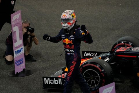 Red Bull driver Max Verstappen of the Netherlands celebrates after winning the pole position for the Formula One Abu Dhabi Grand Prix in Abu Dhabi, United Arab Emirates, Saturday Dec 11, 2021. (AP Photo/Hassan Ammar)