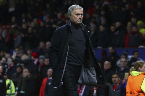 Manchester United head coach Jose Mourinho walks to the dressing room after his side were defeated by Sevilla during the Champions League round of 16 second leg soccer match at Old Trafford in Manchester, England, Tuesday, March 13, 2018. Sevilla won the game 2-1 and go through to the quarterfinals .(AP Photo/Dave Thompson)