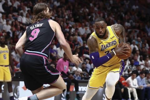 Los Angeles Lakers forward LeBron James drives against Miami Heat forward Kelly Olynyk during the first half of an NBA basketball game Sunday, Nov. 18, 2018, in Miami. (AP Photo/Brynn Anderson)