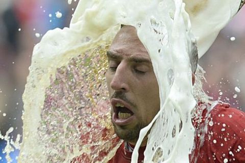 Bayern Munich's French midfielder Franck Ribery is poured with beer by a teammate while celebrating their champion title, after winning 3:0 the German first division Bundesliga football match between Bayern Munich and FC Augsburg in Munich, southern Germany, on May 11, 2013. Munich were confirmed German league champions back on April 6, when they won the Bundesliga with a record six games left to play

AFP PHOTO / CHRISTOF STACHECHRISTOF STACHE/AFP/Getty Images