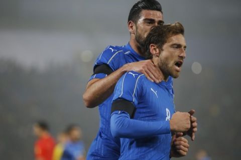 Italys Claudio Marchisio, right, celebrates with his teammate Graziano Pelle after scoring on a penalty kick during a friendly soccer match between Italy and Romania at the Renato Dall'Ara stadium in Bologna, Italy, Tuesday, Nov. 17, 2015. (AP Photo/Luca Bruno)