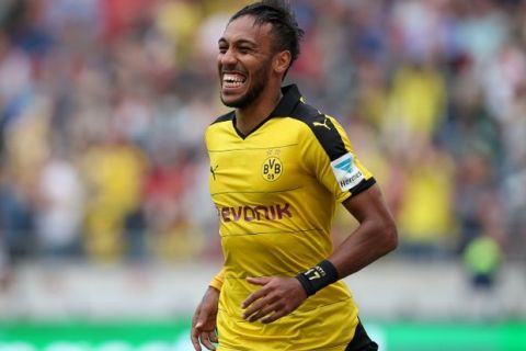 Dortmund's Gabonese striker Pierre-Emerick Aubameyang celebrates his team's third goal during the German first division Bundesliga football match Hannover 96 v Borussia Dortmund, in Hannover, on September 12, 2015.  AFP PHOTO /  RONNY HARTMANN

RESTRICTIONS: DURING MATCH TIME: DFL RULES TO LIMIT THE ONLINE USAGE TO 15 PICTURES PER MATCH AND FORBID IMAGE SEQUENCES TO SIMULATE VIDEO. 
== RESTRICTED TO EDITORIAL USE ==
FOR FURTHER QUERIES PLEASE CONTACT DFL DIRECTLY AT + 49 69 650050.