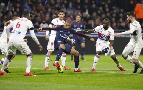 PSG's Kylian Mbappe Lottin, center, is surrounded by Lyon' players during the French League One soccer match between Lyon and Paris Saint Germain in Decines, near Lyon, central France, Sunday, Jan. 21, 2018. (AP Photo/Laurent Cipriani)