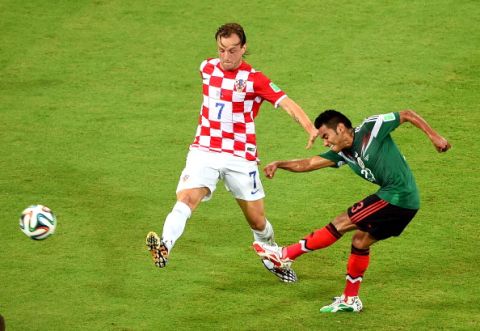 RECIFE, BRAZIL - JUNE 23:  Ivan Rakitic of Croatia and Jose Juan Vazquez of Mexico compete for the ball during the 2014 FIFA World Cup Brazil Group A match between Croatia and Mexico at Arena Pernambuco on June 23, 2014 in Recife, Brazil.  (Photo by Laurence Griffiths/Getty Images)
