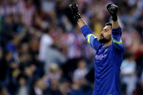 Atletico's goalkeeper Miguel Angel Moya celebrates after his teammate Arda Turan  scored during the Group A Champions League soccer match between Atletico De Madrid and Juventus at the Vicente Calderon stadium in Madrid, Spain, Wednesday, Oct. 1, 2014. (AP Photo/Daniel Ochoa de Olza)