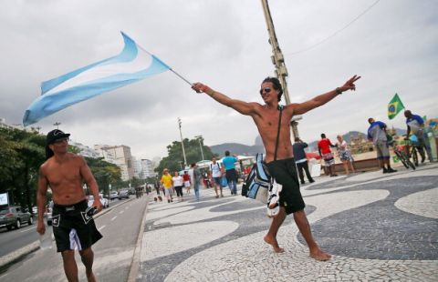 RIO DE JANEIRO, BRAZIL - JULY 11:  Argentine fans celebrate on Copacabana Beach ahead of their 2014 FIFA World Cup final match against Germany on July 11, 2014 in Rio de Janeiro, Brazil. Up to 100,000 Argentine fans are expected to arrive in Rio for the final match which will be held at the famed Maracana stadium on July 13,2014.  (Photo by Mario Tama/Getty Images)