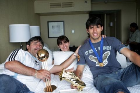 Sergio Aguero with his sister Jesyca, father Leonel and his Under-20 World Cup Golden Ball and Golden Shoe awards