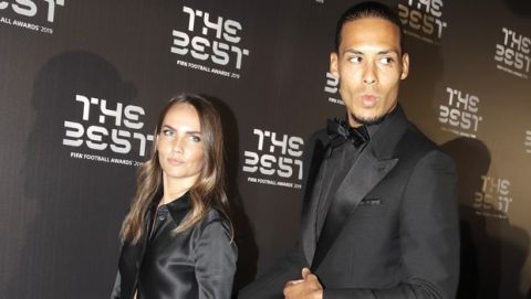 Netherlands defender Virgil van Dijk arrives with his partner Like Nooitgedagt to attend the Best FIFA soccer awards, in Milan's La Scala theater, northern Italy, Monday, Sept. 23, 2019. Virgil van Dijk is up against five-time winners Cristiano Ronaldo and Lionel Messi for the FIFA best player award and United States forward Megan Rapinoe is the favorite for the women's award. (AP Photo/Luca Bruno)