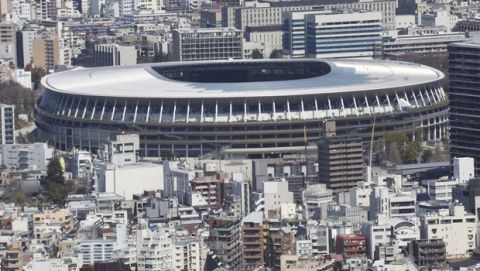 The New National Stadium, a venue designed for the opening and closing ceremonies for the Tokyo 2020 Olympics, is seen prominently in the Tokyo cityscape seen from an observation tower, Wednesday, March 25, 2020. (AP Photo/Koji Sasahara)