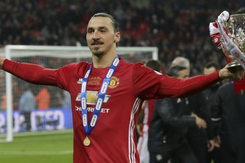 Manchester United's Zlatan Ibrahimovic holds the trophy after Manchester won the English League Cup final soccer match between Manchester United and Southampton FC at Wembley stadium in London, Sunday, Feb. 26, 2017. (AP Photo/Tim Ireland)