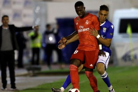Real Madrid's Vinicius Junior, left, duels for the ball during the Spanish Copa del Rey soccer match between Melilla and Real Madrid at the Municipal Alvarez Claro stadium in the Spain's enclave of Melilla, Wednesday, Oct. 31, 2018.(AP Photo/Javier Gandul)