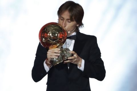Real Madrid's Luka Modric celebrates with the Ballon d'Or award during the Golden Ball award ceremony at the Grand Palais in Paris, France, Monday, Dec. 3, 2018. Awarded every year by France Football magazine since Stanley Matthews won it in 1956, the Ballon d'Or, Golden Ball for the best player of the year will be given to both a woman and a man. (AP Photo/Christophe Ena)