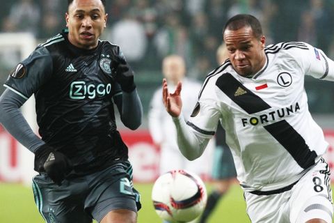Kenny Tete, left, from Ajax and Vadis Odjidja Ofoe from Legia challenge for the ball during the Europa League round of 32 first leg soccer match between Legia Warsaw and Ajax Amsterdam at Stadion Wojska Polskiego in Warsaw, Poland, Thursday, Feb. 16, 2017. (AP Photo/Czarek Sokolowski)