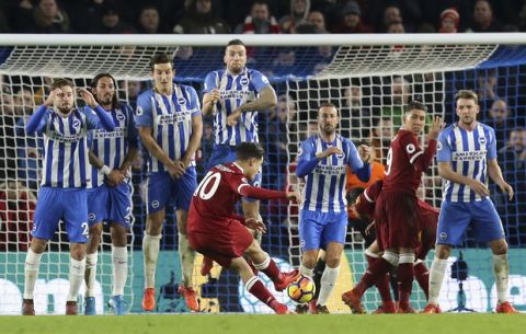 Liverpool's Philippe Coutinho scores his side's fourth goal during the English Premier League soccer match between Brighton & Hove Albion and Liverpool FC at the AMEX stadium, Brighton, England. Saturday. Dec. 2, 2017. (Gareth Fuller/PA via AP)