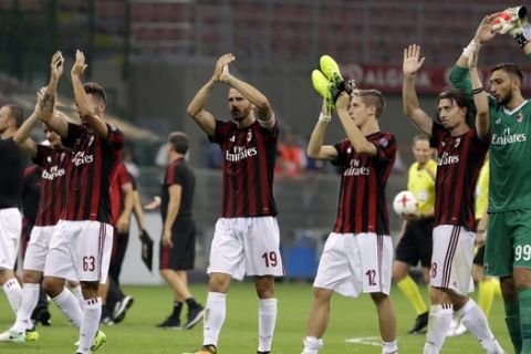 AC Milan players celebrate their 6-0 win at the end of the Europa League, play-off, first-leg soccer match between AC Milan and Shkendija, at the Milan San Siro Stadium, Italy, Thursday, Aug.17, 2017. (AP Photo/Antonio Calanni)