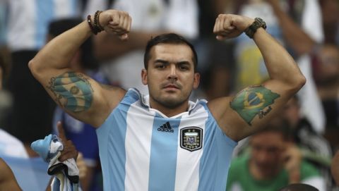 A fan shows his tattoos of Brazil and Argentina flags at the end of a Copa America semifinal soccer match at the Mineirao stadium in Belo Horizonte, Brazil, Tuesday, July 2, 2019. (AP Photo/Natacha Pisarenko)
