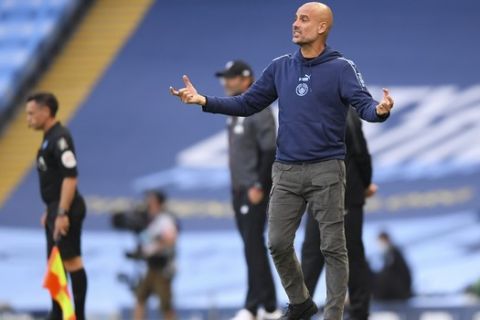 Manchester City's head coach Pep Guardiola gestures during the English Premier League soccer match between Manchester City and Liverpool at Etihad Stadium in Manchester, England, Thursday, July 2, 2020. (AP Photo/Laurence Griffiths,Pool)