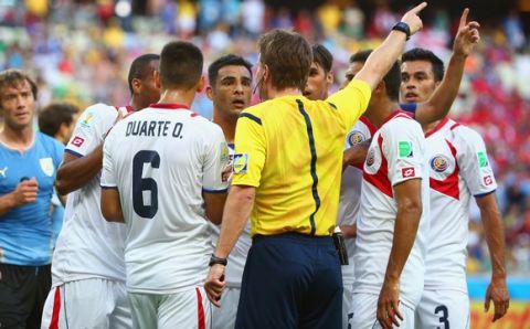 FORTALEZA, BRAZIL - JUNE 14: Costa Rica surround referee Felix Brych after a foul awarding Uruguay a penalty kick during the 2014 FIFA World Cup Brazil Group D match between Uruguay and Costa Rica at Castelao on June 14, 2014 in Fortaleza, Brazil.  (Photo by Robert Cianflone/Getty Images)