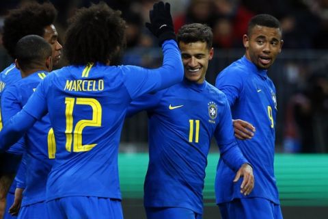 Brazil's Philippe Coutinho, 2nd right, celebrates after scoring his side's second goal during an international friendly soccer match between Russia and Brazil at the Luzhniki stadium in Moscow, Russia, Friday, March 23, 2018. (AP Photo/Alexander Zemlianichenko)