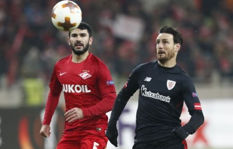 Athletic's Aritz Aduriz, right, challenges for the ball with Spartak's Serdar Tasci during the Europa League, round of 32 first-leg soccer match between Spartak Moscow and Athletic Club Bilbao at the Otkrytiye Arena in Moscow, Russia, Thursday, Feb. 15, 2018. (AP Photo/Pavel Golovkin)