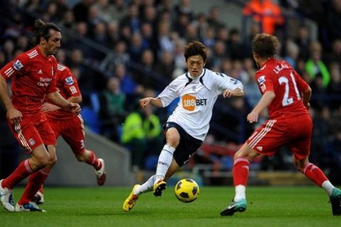 BOLTON, ENGLAND - OCTOBER 31:  Chung Yong Lee of Bolton Wanderers looks for a way past the challenge of Lucas of Liverpool during the Barclays Premier League match between Bolton Wanderers and Liverpool at the Reebok Stadium on October 31, 2010 in Bolton, England. (Photo by Laurence Griffiths/Getty Images)