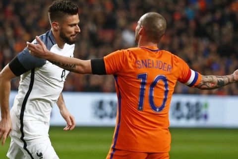 Netherlands' Wesley Sneijder gestures after Frances Olivier Giroud, left, scored his sides second goal during a international friendly soccer match between The Netherlands and France at the ArenA stadium in Amsterdam, Netherlands, Friday, March 25, 2016. The players were wearing mourning bands to commemorate the victims of the Brussels attacks. (AP Photo/Peter Dejong)