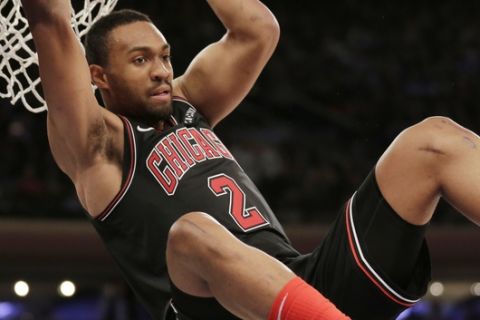 Chicago Bulls' Jabari Parker hangs on the rim after slamming the ball during the first overtime of the NBA basketball game against the New York Knicks, Monday, Nov. 5, 2018, in New York. The Bulls defeated the Knicks in double overtime 116-115. (AP Photo/Seth Wenig)