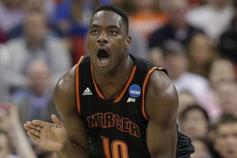 Mercer guard Ike Nwamu (10) celebrates during the first half of an NCAA college basketball second-round game against Duke, Friday, March 21, 2014, in Raleigh, N.C. (AP Photo/Chuck Burton)
