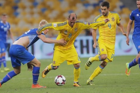 Ukraine's Roman Zozulya, center left, challenges for the ball with Iceland's Hordur Magnusson, left, during World Cup Group I qualifying soccer match between Ukraine and Iceland at the Olympiyskiy stadium in Kiev, Ukraine, Monday, Sept. 5, 2016. (AP Photo/Efrem Lukatsky)