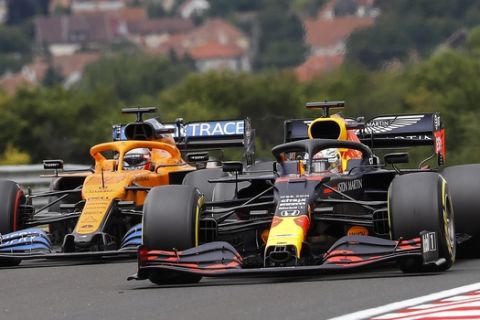 Red Bull driver Max Verstappen of the Netherlands, right, and Mclaren driver Carlos Sainz of Spain, left, steer their cars during the third practice session for the Hungarian Formula One Grand Prix at the Hungaroring racetrack in Mogyorod, Hungary, Saturday, July 18, 2020. The Hungarian F1 Grand Prix will be held on Sunday. (Leonhard Foeger/Pool via AP)