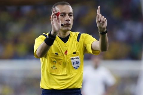 Referee Cuneyt Cakir gestures during the group H World Cup soccer match between Algeria and Russia at the Arena da Baixada in Curitiba, Brazil, Thursday, June 26, 2014. (AP Photo/Jon Super)