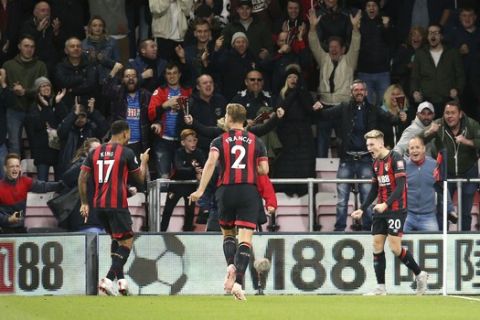 Bournemouth's David Brooks, right, celebrates scoring his side's first goal during the British Premier League soccer match between Bournemouth and Crystal Palace, at the Vitality Stadium in Bournemouth, England, Monday, Oct. 1, 2018. (Nigel French/PA via AP)