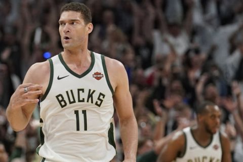 Milwaukee Bucks' Brook Lopez reacts to his three-point basket during the second half of Game 1 of the NBA Eastern Conference basketball playoff finals against the Toronto Raptors Wednesday, May 15, 2019, in Milwaukee. The Bucks won 108-100 to take a 1-0 lead in the series. (AP Photo/Morry Gash)