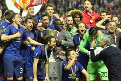 United manager Jose Mourinho, foreground right, gestures to the players celebrating after winning the soccer Europa League final between Ajax Amsterdam and Manchester United at the Friends Arena in Stockholm, Sweden, Wednesday, May 24, 2017. United won 2-0. (AP Photo/Martin Meissner)