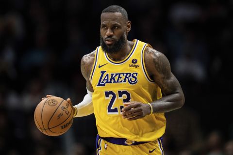 Los Angeles Lakers forward LeBron James (23) brings the ball up court against the Charlotte Hornets during the second half of an NBA basketball game Monday, Feb. 5, 2024, in Charlotte, N.C. (AP Photo/Jacob Kupferman)