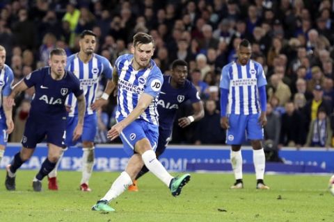 Brighton's Pascal Gross scores his side's first goal of the game from the penalty spot during the English Premier League soccer match between Brighton and Tottenham Hotspur, at the AMEX Stadium, in Brighton, England, Tuesday April 17, 2018. (Gareth Fuller/PA via AP)