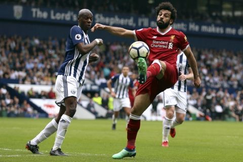 West Bromwich Albion's Allan Nyom, left and Liverpool's Mohamed Salah battle for the ball, during the English Premier League soccer match between West Bromwich Albion and Liverpool, at The Hawthorns, West Bromwich, England, Saturday April 21, 2018. (Nigel French/PA via AP)
