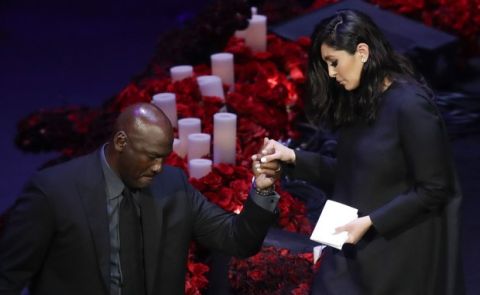 Vanessa Bryant is helped off the stage by former NBA player Michael Jordan after speaking during a celebration of life for her husband Kobe Bryant and daughter Gianna Monday, Feb. 24, 2020, in Los Angeles. (AP Photo/Marcio Jose Sanchez)