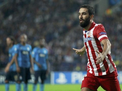 Atletico Madrid's Arda Turan celebrates after scoring a goal against Porto during their Champions League soccer match at Dragao stadium in Oporto, northern Portugal, October 1, 2013.      REUTERS/Jose Manuel Ribeiro (PORTUGAL  - Tags: SPORT SOCCER)  