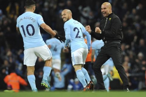 Manchester City manager Josep Guardiola, right, celebrates after Manchester City's Raheem Sterling scored his side second goal during the English Premier League soccer match between Manchester City and Southampton at Etihad stadium, in Manchester, England, Wednesday, Nov. 29, 2017. (AP Photo/Rui Vieira)