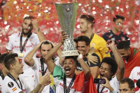 Sevilla's Fernando holds the trophy after winning the Europa League final soccer match between Sevilla and Inter Milan in Cologne, Germany, Friday, Aug. 21, 2020. (Lars Baron, Pool Photo via AP)