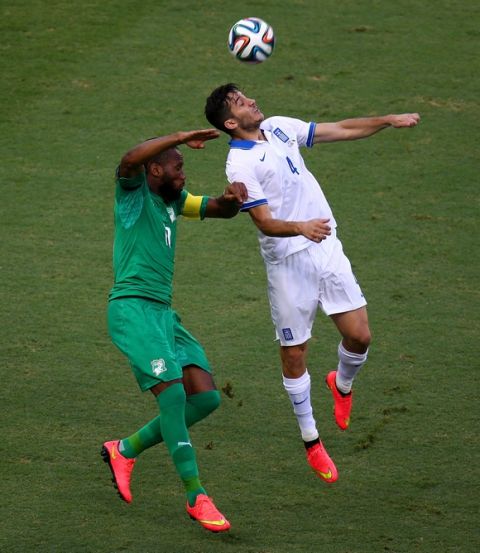 FORTALEZA, BRAZIL - JUNE 24: Didier Drogba of the Ivory Coast and Konstantinos Manolas of Greece go up for a header during the 2014 FIFA World Cup Brazil Group C match between Greece and the Ivory Coast at Castelao on June 24, 2014 in Fortaleza, Brazil.  (Photo by Robert Cianflone/Getty Images)