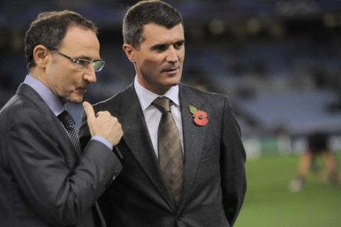 Newly appointed Ireland national soccer team coach Martin O'Neill, left, and Roy Keane, who will be his assistant, speak before Manchester United and Real Sociedad face each other in a Champions League Group A soccer match at Anoeta stadium in San Sebastian, northern Spain, Tuesday, Nov. 5, 2013. (AP Photo/Alvaro Barrientos)