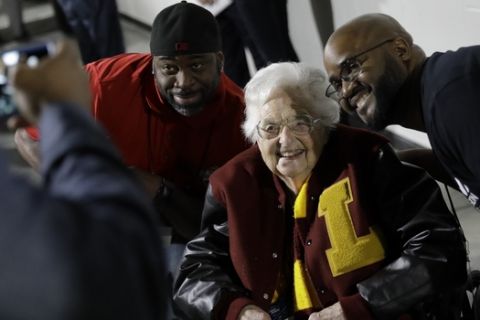 Loyola-Chicago basketball chaplain Sister Jean Dolores Schmidt, poses with fans for a photo before the first half of a regional final NCAA college basketball tournament game, Saturday, March 24, 2018, in Atlanta. (AP Photo/David Goldman)