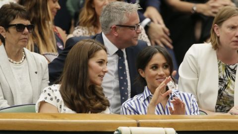 Kate, Duchess of Cambridge and Meghan, Duchess of Sussex, right, sit in the Royal Box on Centre Court ahead of the women's singles final match between Serena Williams of the US and Angelique Kerber of Germany at the Wimbledon Tennis Championships, in London, Saturday July 14, 2018. (AP Photo/Tim Ireland)